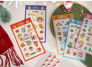 Close-up of festive Christmas stickers with Santa and reindeer on a decorative tray