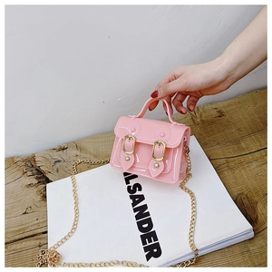 Detailed view of pink jelly Cambridge bag with golden chain and magnetic clasp closure