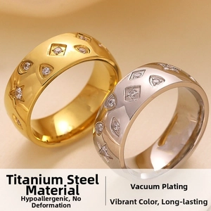 Macro shot of gold and silver titanium steel rings with cubic zirconia geometric patterns