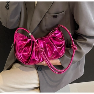Detail of metallic fuchsia pleated cloud bag showing glossy leather and shoulder knot