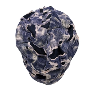 Macro detail of camouflage tie-dye knitted beanie with vintage distressed ripped holes