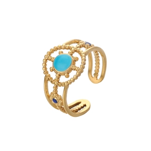 Detailed macro of gold vintage ring featuring blue stone and hollow floral pattern