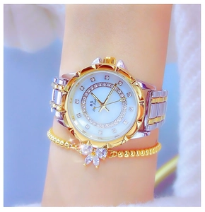 Detailed close-up of luxury women's watch with crystal dial and floral bezel on wrist
