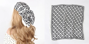 Close-up of black and white Greek fret pattern satin square scarf worn as a headscarf