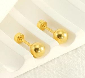 Minimalist gold ball stud earrings displayed on white geometric steps with screw backs