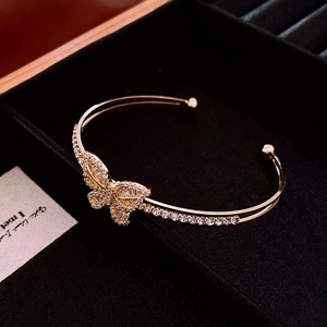 Detailed view of a gold-plated butterfly bangle featuring shimmering cubic zirconia stones