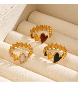 Close-up of adjustable 18K gold-plated heart rings in red, black, and marble white