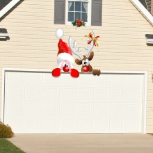 Close-up of Santa and Reindeer magnetic stickers on white garage door decor