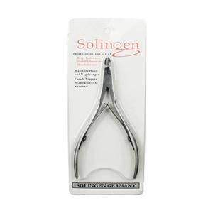Macro shot of silver cuticle nippers in retail blister card packaging with labeling