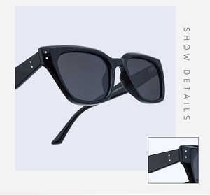 Detail view of black polarized sunglasses showing the frame profile and hinge craftsmanship