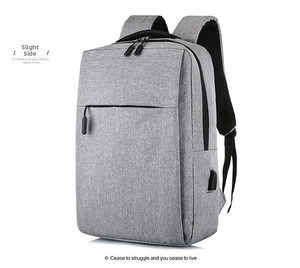 Detail of grey business backpack showing water-resistant fabric and side USB charging port