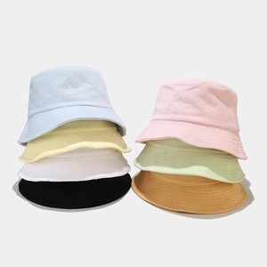Close-up of soft towel fabric texture and star embroidery on colorful bucket hats