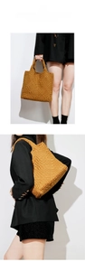 Detailed view of brown woven leather tote bag showcasing premium textured craft and dual straps
