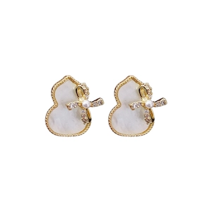 Elegant gold-plated gourd earrings with white inlay, bows and pearls on white background