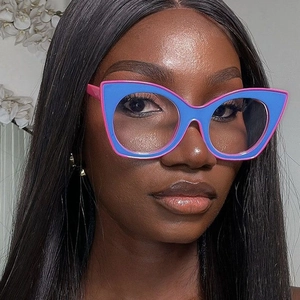 Close-up of blue and pink cat-eye glasses frame worn by a model in a fashion shot