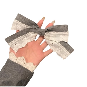 Elegant grey ribbon bow hair clip with white lace trim for sophisticated hairstyles