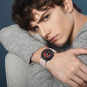Close-up of light pink silicone watch strap on Galaxy Watch 6 with sleek round dial