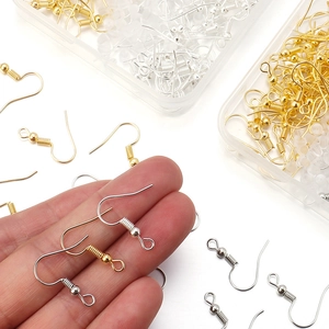 Gold and silver metal earring hooks with spring and ball findings in clear storage boxes