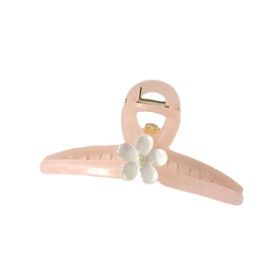 Pink matte flower claw clip with pearlescent white petal and golden metal spring