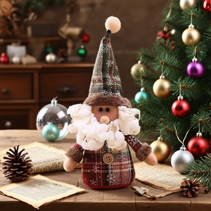Close-up of handmade Christmas gnome ornament with plaid hat and fluffy white beard