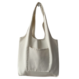 Minimalist beige canvas tote bag with front pocket for daily travel and students