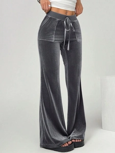 Detail view of grey velvet flare pants featuring elastic drawstring waist and soft texture