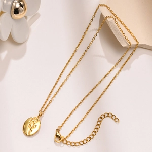 Detail of golden oval pendant with rose embossing and adjustable extender chain