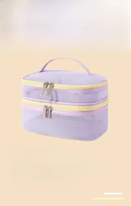 Detail view of double-layer lavender mesh cosmetic bag with top handle for travel
