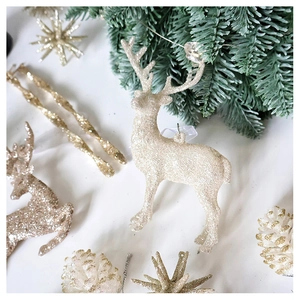 Champagne glitter reindeer and pine cone ornaments displayed on festive pine branches