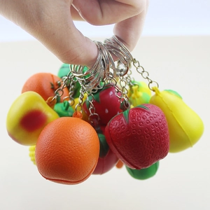 Variety of realistic mini fruit keychains including strawberry orange and apple charms