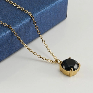 18K gold plated stainless steel necklace featuring a round black zircon pendant on a gift box