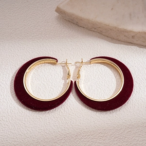 Elegant 18K gold plated hoop earrings with burgundy velvet flocking on stone background