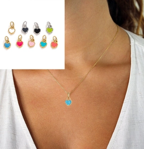 Macro view of colorful heart-shaped oil-drip pendants with gold and silver metal bases