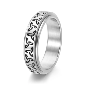 Macro shot of silver Viking Celtic knot spinner ring with engraved trinity pattern texture