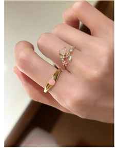 Detail of s925 silver flower rings with pink floral elements and sparkling crystals