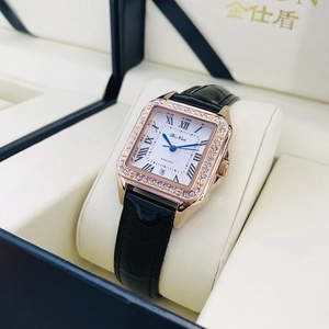 Detail of rose gold square watch with crystal bezel and black leather strap in luxury box