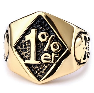 Detailed view of vintage gold 1%er biker ring with skull relief and engraved text