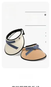 Detailed view of UPF 50+ woven sun hats in beige and brown with blue bow ribbons