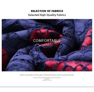 Detail of dark blue lace fabric with floral embroidery and soft red lining texture