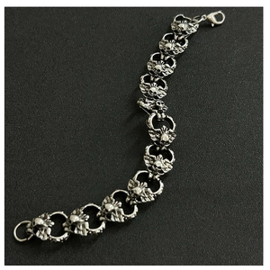 Detail of silver gothic bracelet featuring winged skulls and a secure lobster clasp