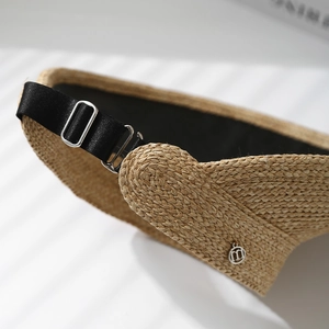 Macro shot of high-quality woven straw texture and adjustable silver metal buckle on hat