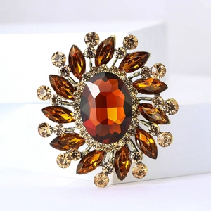 Macro view of vintage sunflower brooch with amber crystal and golden metal setting