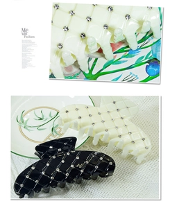 Close-up of large hair claw clips featuring quilted texture and small rhinestones