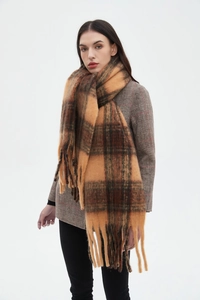 Detail view of the brown and orange plaid winter scarf with long decorative tassels