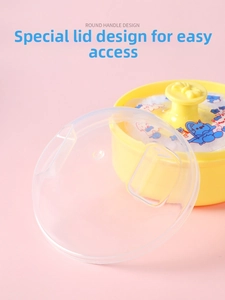 Detailed view of yellow baby powder puff case with round handle and transparent lid