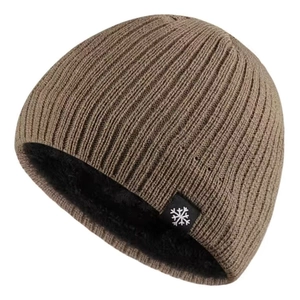 Close-up of brown knitted beanie showing soft black fleece lining for winter warmth