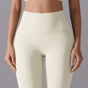 Detailed close-up of high-waisted seamless beige yoga pants with smooth nude-feel fabric