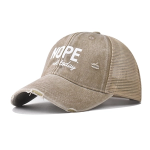 Distressed khaki NOPE mesh trucker hat showing side view and vintage washed cotton texture