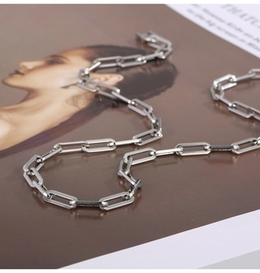 Macro shot of silver rectangular paperclip chain with polished metallic mirror finish