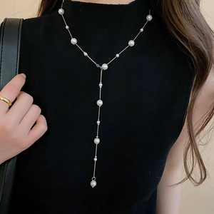 Elegant long Y-shaped pearl necklace featuring silver chain with white artificial pearls
